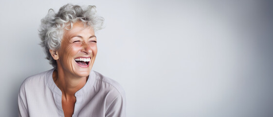 Generative AI image of 
a closeup photo portrait of a beautiful elderly senior model woman with grey hair laughing and smiling with clean teeth. used for a dental ad. isolated on white background