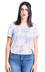 Obraz premium Young beautiful girl wearing casual t shirt in shock face, looking skeptical and sarcastic, surprised with open mouth