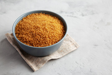 Organic Brown Sugar in a Bowl, side view. Copy space.