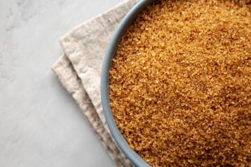 Organic Brown Sugar in a Bowl, top view. Flat lay, overhead, from above. Close-up.
