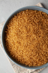 Organic Brown Sugar in a Bowl, top view. Flat lay, overhead, from above. Close-up.