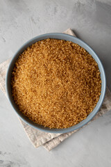 Organic Brown Sugar in a Bowl, top view. Flat lay, overhead, from above. Close-up.