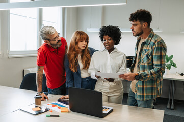 Multicultural businesspeople is collaborating on a data research at the office.