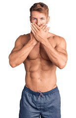 Fototapeta premium Young caucasian man standing shirtless shocked covering mouth with hands for mistake. secret concept.