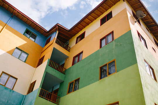 Vibrant multicolored apartment building under blue sky in Guatapé
