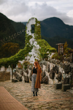 Contemplative woman at a historic stone church ruins in Bogot&aacute;, Colombia