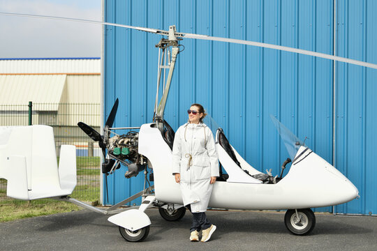 A woman near two-seater white gyrocopter