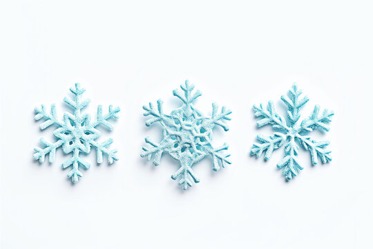 The image shows three distinct snowflake designs with a light blue hue, presented in a row against a white background