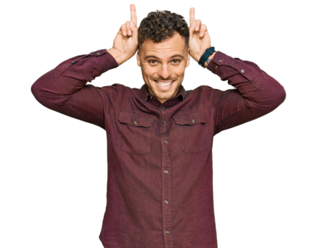 Young hispanic man wearing casual clothes posing funny and crazy with fingers on head as bunny ears, smiling cheerful