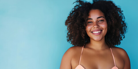 Portrait of a radiant plus-size woman in stylish swimwear against a flat blue background with copy space, banner template, celebrating body positivity. Confident Plus-Size Model portrait in Swimwear. - obrazy, fototapety, plakaty
