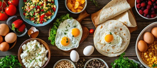 Poster Nourishing meal or snack for tortilla wraps, eggs, cottage cheese, fruits, and veggies. © AkuAku