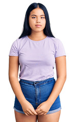 Obraz premium Young beautiful asian girl wearing casual clothes with serious expression on face. simple and natural looking at the camera.