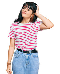 Young hispanic girl wearing casual clothes confuse and wondering about question. uncertain with...