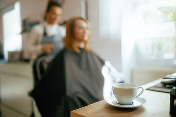 Closeup on cup of hot beverage in hair salon