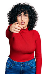 Young middle east girl wearing casual clothes and glasses pointing displeased and frustrated to the camera, angry and furious with you