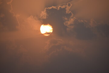 Golden Horizon: Sunset in Village with Clouds.This mesmerizing image captures the serene beauty of...