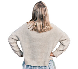 Young blonde woman wearing glasses standing backwards looking away with arms on body