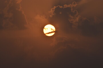 Golden Horizon: Sunset in Village with Clouds.This mesmerizing image captures the serene beauty of...