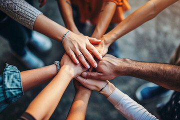 A group of people with their hands together. Business teamwork and support - obrazy, fototapety, plakaty