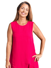 Fototapeta premium Middle age hispanic woman wearing casual clothes looking positive and happy standing and smiling with a confident smile showing teeth
