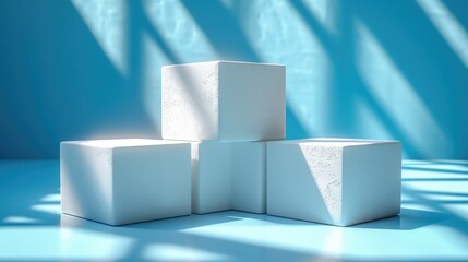 Three white cubes sitting on top of a blue surface.