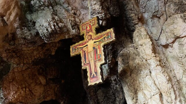 ancient Crucifix hanging from the top of a cavern 