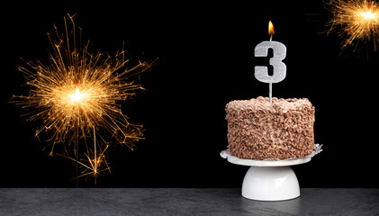 Birthday celebration with cake and candle number 3