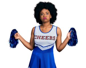 Young african american woman wearing cheerleader uniform using pompom puffing cheeks with funny face. mouth inflated with air, catching air.