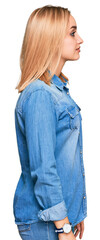 Beautiful caucasian woman wearing casual denim jacket looking to side, relax profile pose with natural face with confident smile.