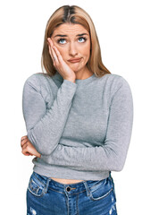 Fototapeta premium Young caucasian woman wearing casual clothes thinking looking tired and bored with depression problems with crossed arms.