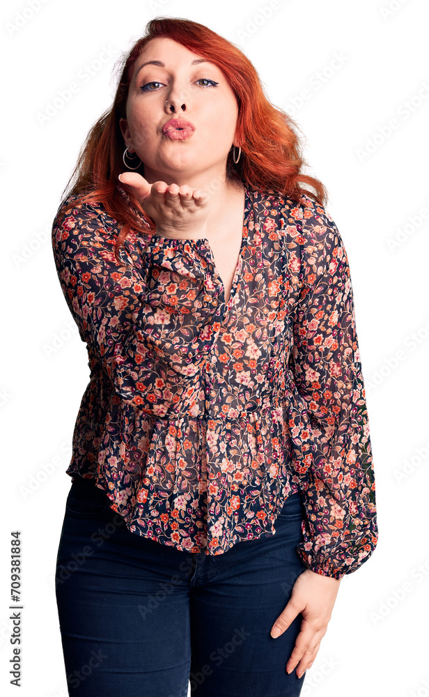 Sticker young beautiful redhead woman wearing casual t-shirt looking at the camera blowing a kiss with hand 