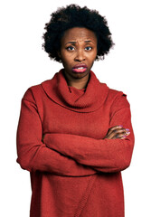 African american woman with afro hair with arms crossed gesture clueless and confused expression....