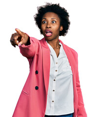 African american woman with afro hair wearing business jacket pointing with finger surprised ahead,...