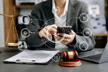  Male judge in a courtroom the gavel, working with smart phone and laptop and digital tablet...