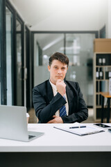 Obraz na płótnie Canvas Mature businessman executive manager looking at laptop watching online webinar training or having virtual meeting video conference doing market research working in office..