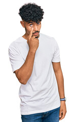 Fototapeta na wymiar Young arab man wearing casual white t shirt pointing to the eye watching you gesture, suspicious expression