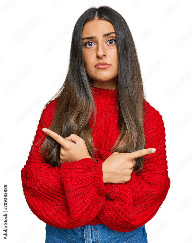 Wall mural Beautiful hispanic woman wearing casual clothes pointing to both sides with fingers, different direction disagree