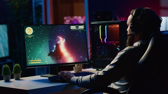 Man at home shooting asteroids in spaceship flying singleplayer game with overlay HUD showing health, fuel, ammo bars and minimap. Gamer navigating universe in simulation game, chatting with friends