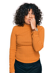 Young hispanic woman wearing casual clothes looking stressed and nervous with hands on mouth biting nails. anxiety problem.