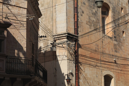 Messy electrical cables on wall corner in Malta