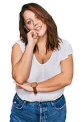 Young plus size woman wearing casual white t shirt looking confident at the camera smiling with...