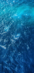 Fototapeta premium Top view of blue frothy sea surface. Shot in the open sea from above.