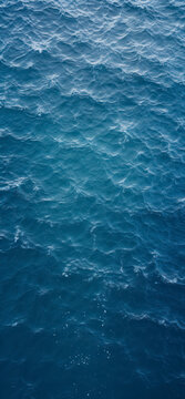 Top view of blue frothy sea surface. Shot in the open sea from above.