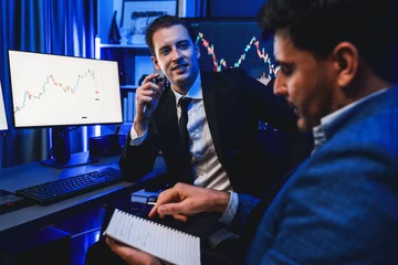 Foto op Canvas Two stock exchange traders discussing on dynamic investment graph, trending of high profit in currency stock. Showing financial benefit data on monitor screen in neon light at workplace. Sellable. © Summit Art Creations