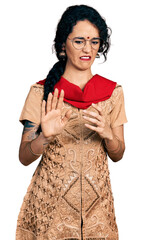 Young indian woman wearing traditional dress and glasses disgusted expression, displeased and...
