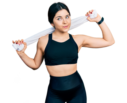 Young brunette woman with blue eyes wearing sportswear and towel smiling looking to the side and staring away thinking.