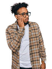 Young african american man with beard wearing casual clothes and glasses tired hands covering face, depression and sadness, upset and irritated for problem