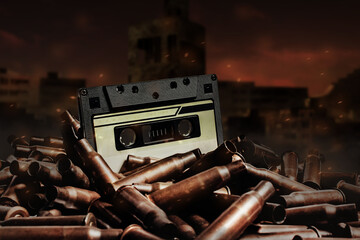 Photo of an old retro audio tape cassette on pile of bullets. Ruined city wasteland background.