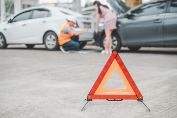 red emergency triangle on the road indicates that there is an accident or car breakdown on the road...