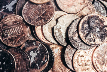Photo of a pile of american Lincoln cent, penny damaged and rusty coins.